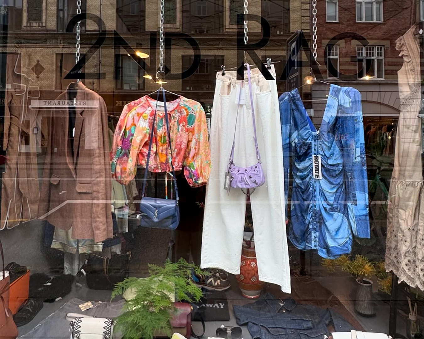 Secondhand womenswear in the shop window at 2nd Rag shop in Copenhagen.