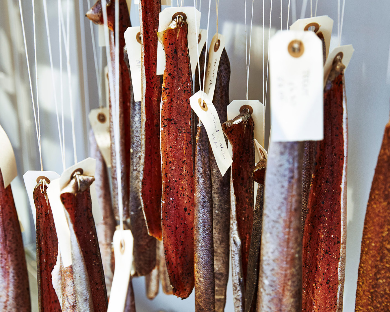 Cured wild trout hanging on string at Copenhagen restaurant Geranium.