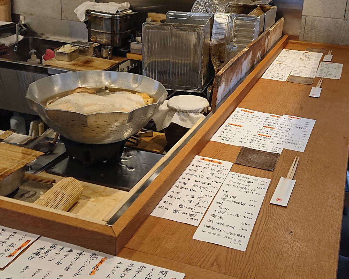 Bar seating beside the open kitchen at Washoku Haru restaurant in Kyoto.