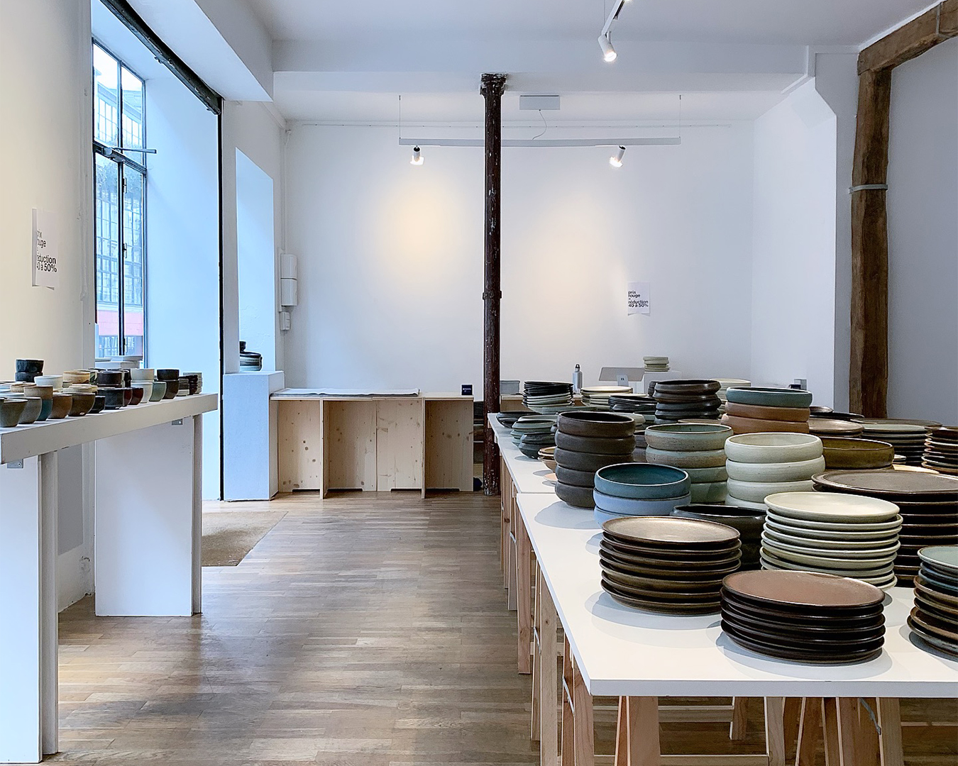 Interior view of a pottery studio with handcrafted ceramic plates.