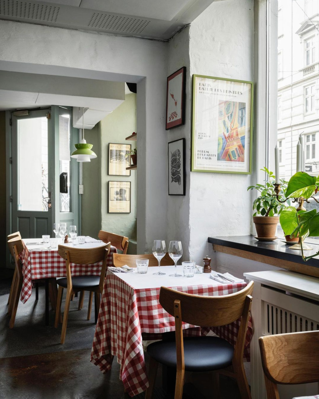 Gingham tablecloths drape over small tables inside bistro Silberbauers in Copenhagen