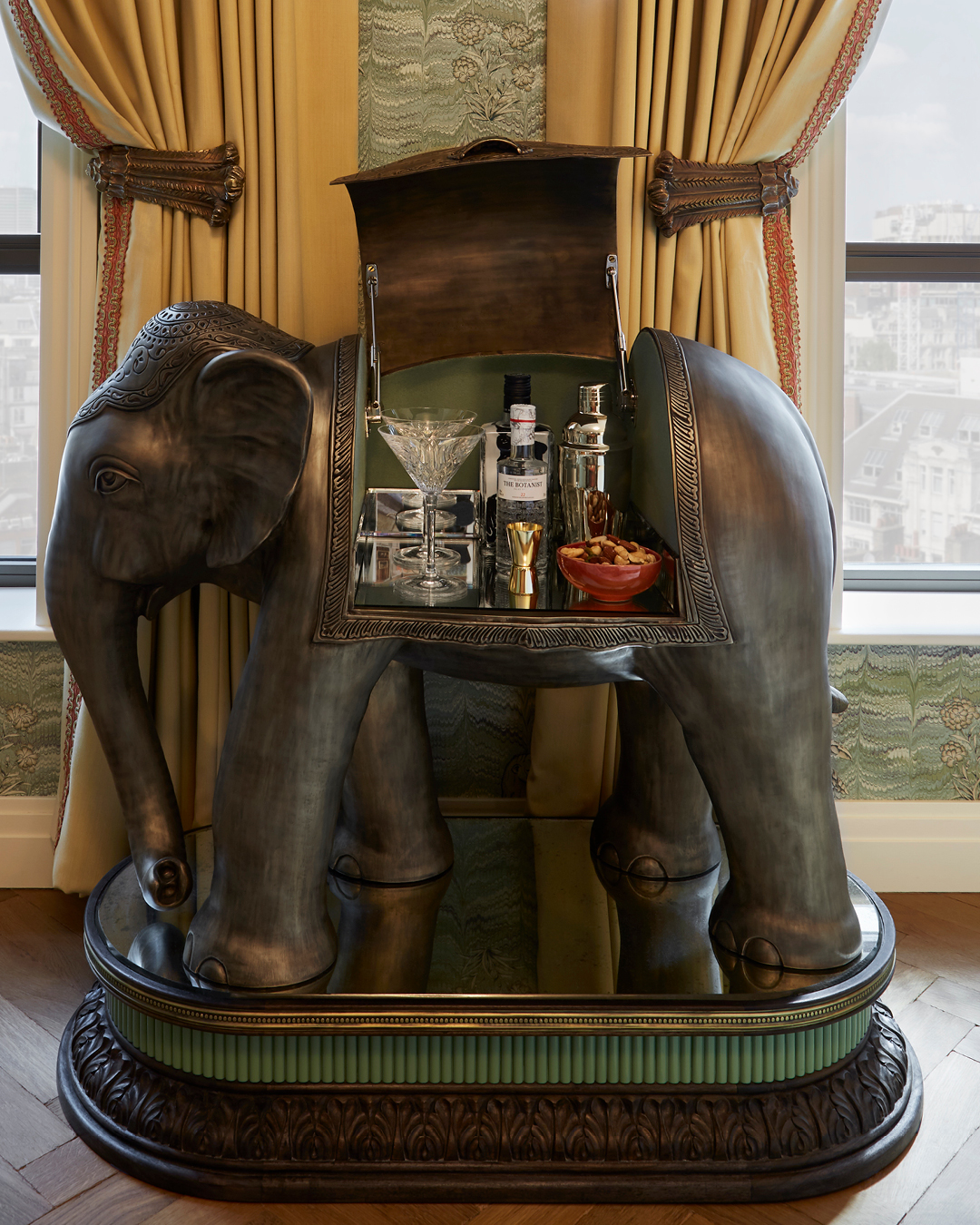 Unique elephant mini bar in a room at Broadwick Soho, London, featuring an ornate design and stocked with premium beverages.