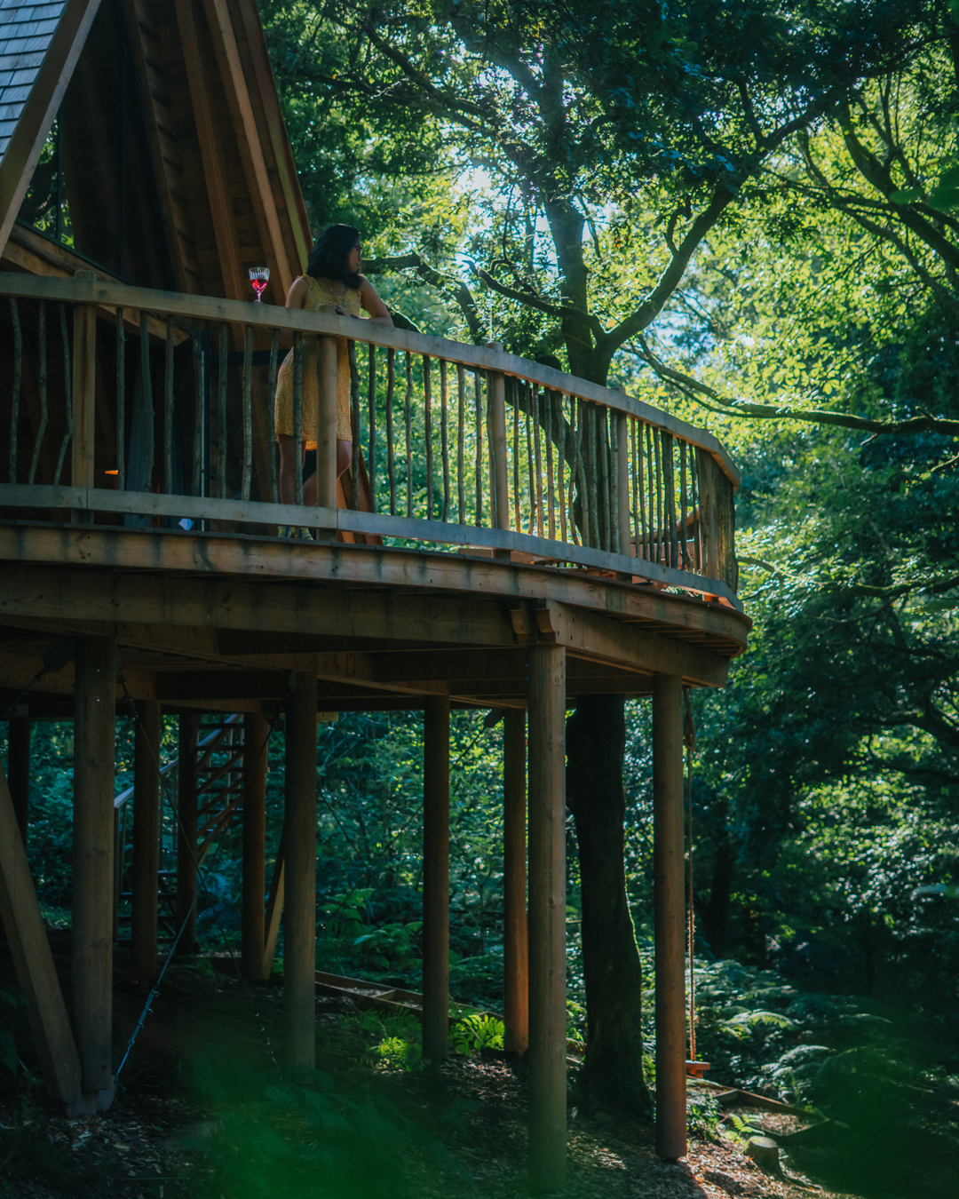 A person enjoying views from the balcony at The Hudnalls Hideout, Gloucestershire.