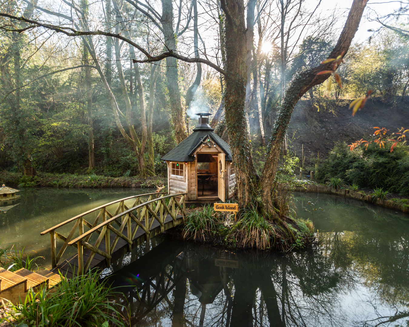 A barbecue hut in a duck pond at Squirrel Nest Treehouse, Gloucestershire.