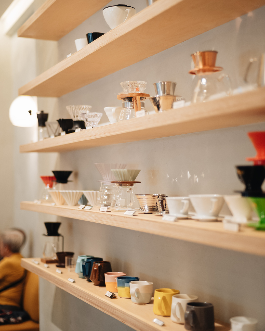 Mugs, V60s and other coffee accessories on display at Kurasu in Singapore.