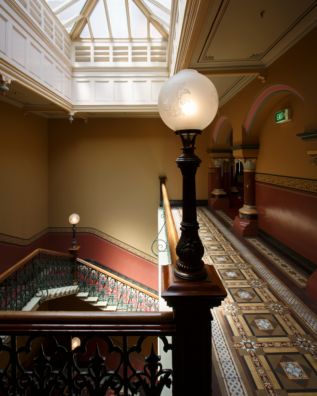 The grand and regal staircase lined with heritage lamps at The Hotel Windsor, Melbourne