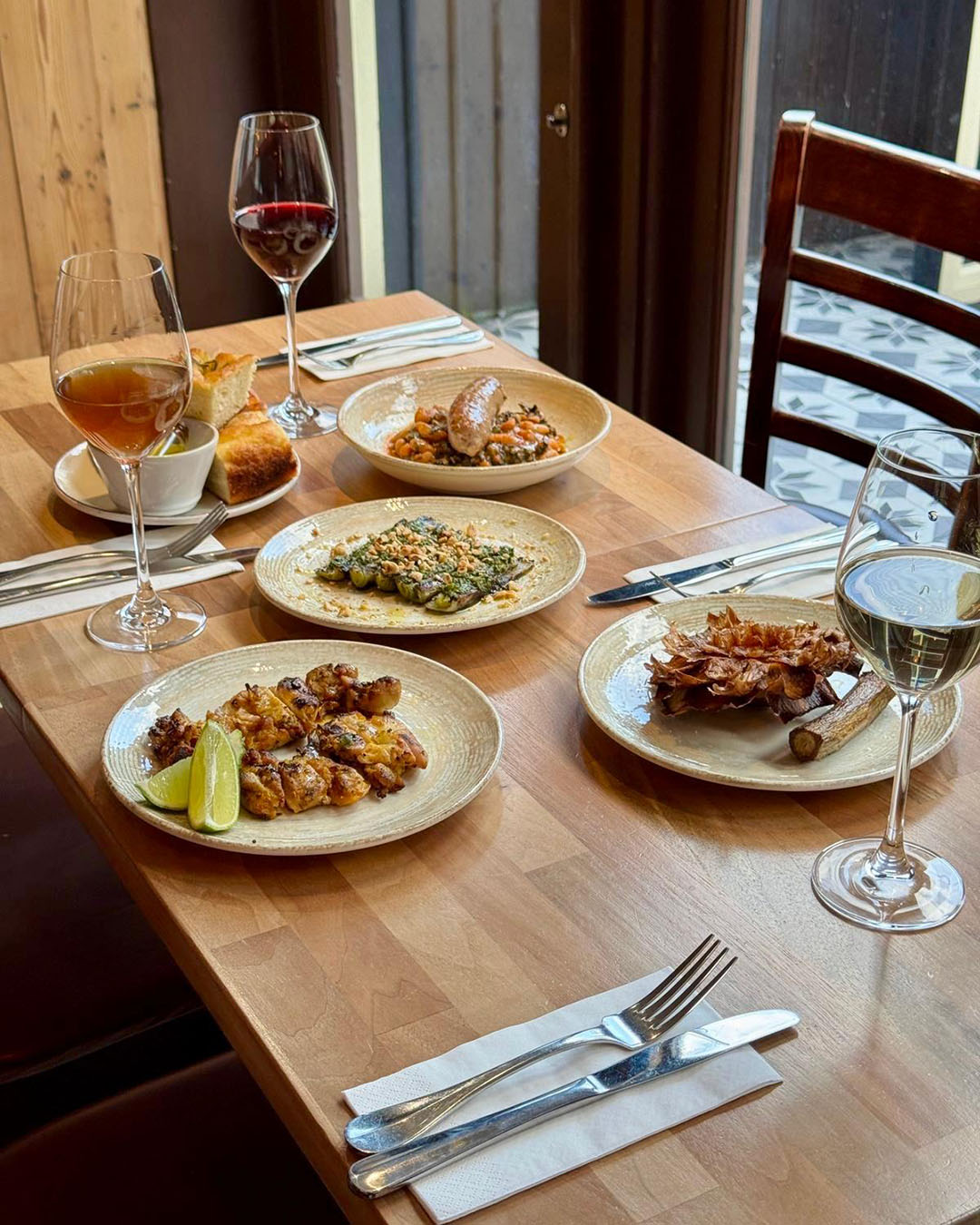 Wine and plates of food at The Remedy wine bar and restaurant in Fitzrovia