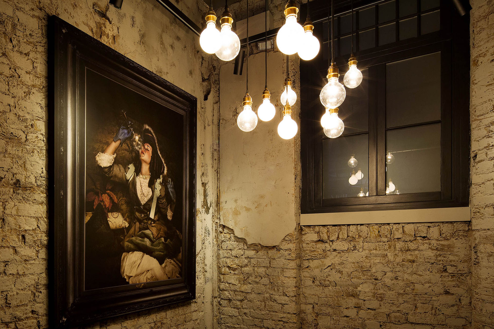 Exposed brick and ambient hanging light bulbs at Comptoir Café & Wine, Mayfair