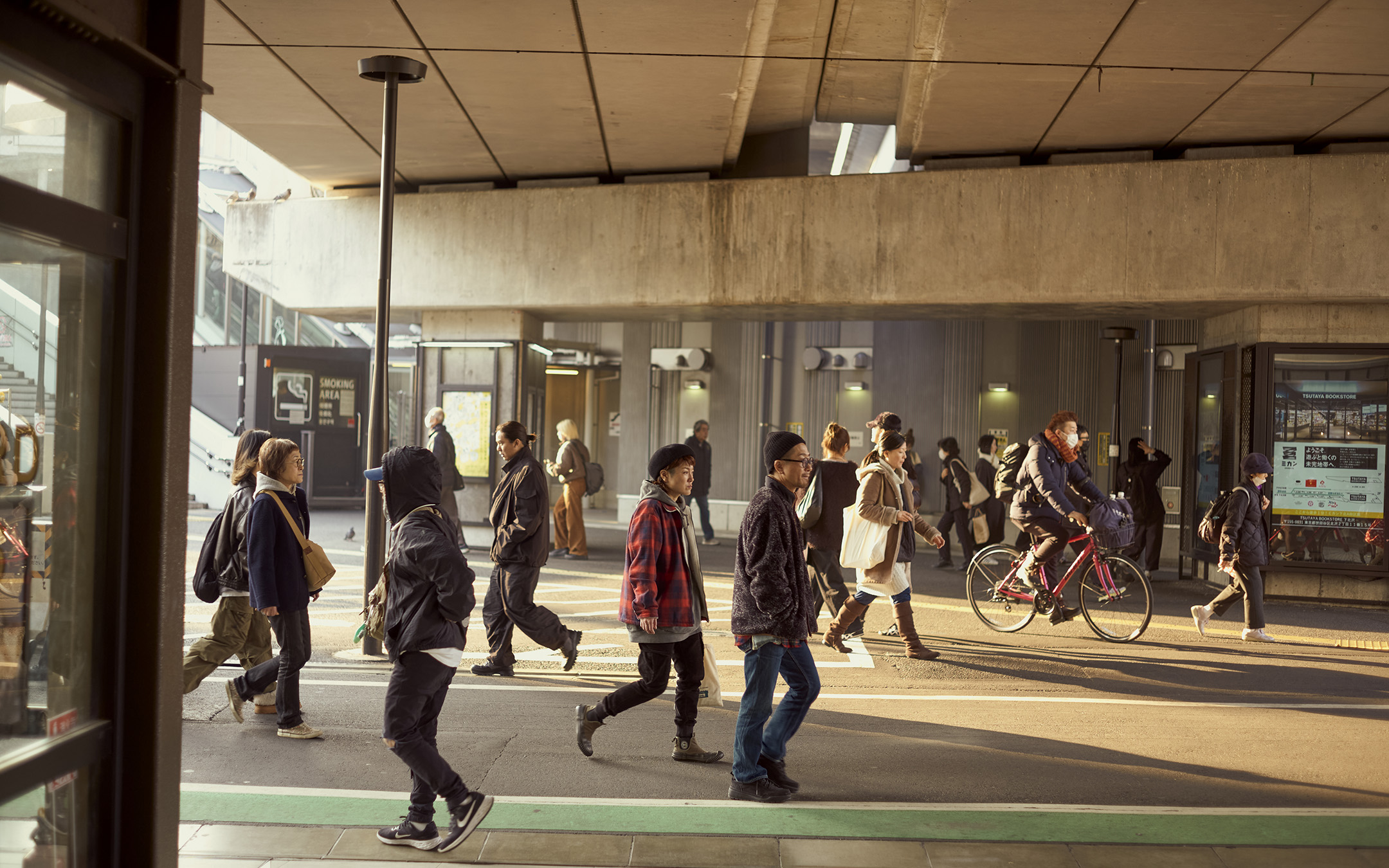 People walking beneath an undercarriage in Shimokitazawa, Tokyo