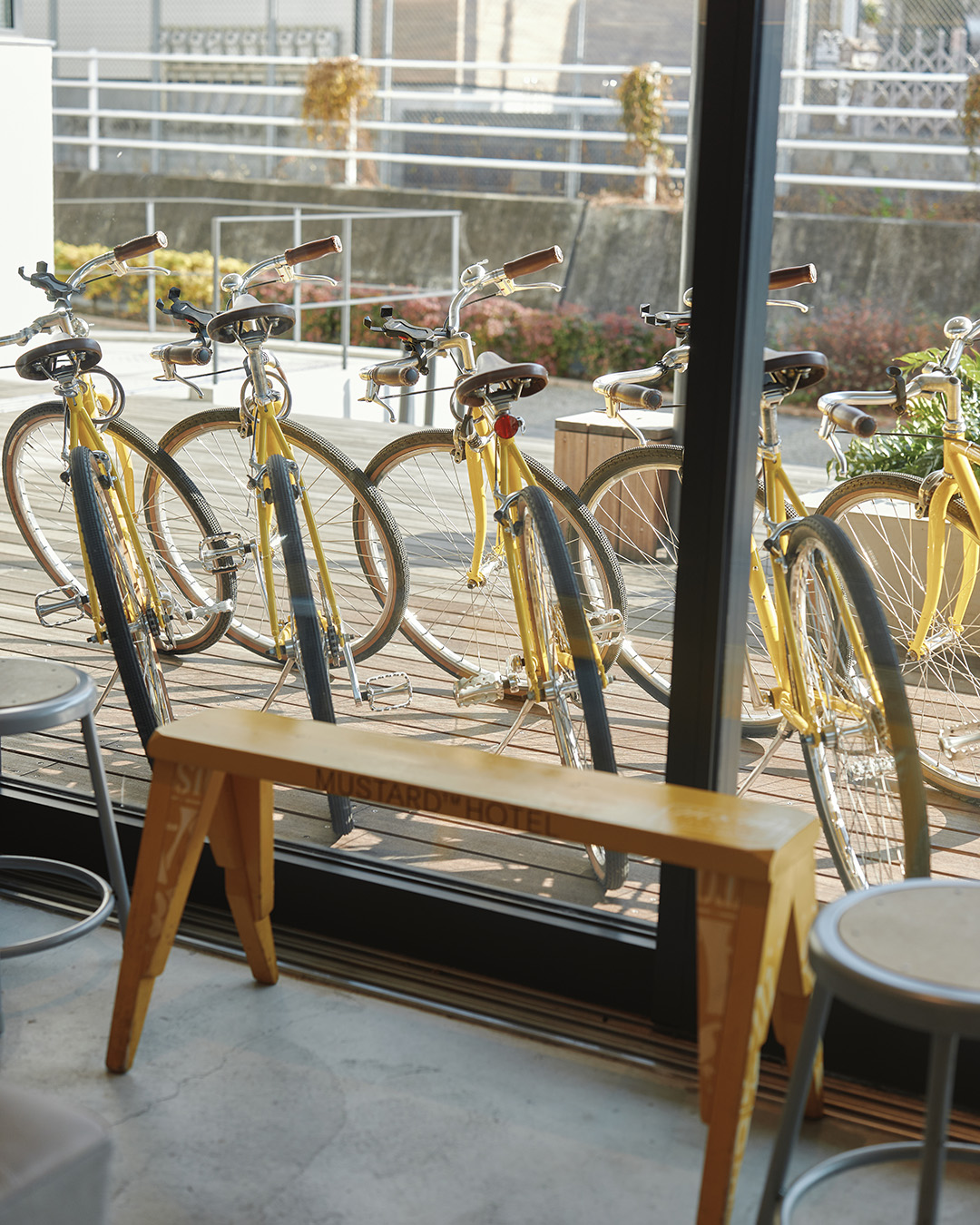 Complimentary yellow bikes outside Mustard Hotel. Photography by Irwin Wong