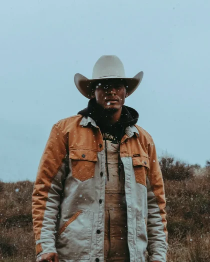 Ronnie Davis, a black cowboy in cowboy hat wearing jacket in Owyhee Canyonlands, Oregon.