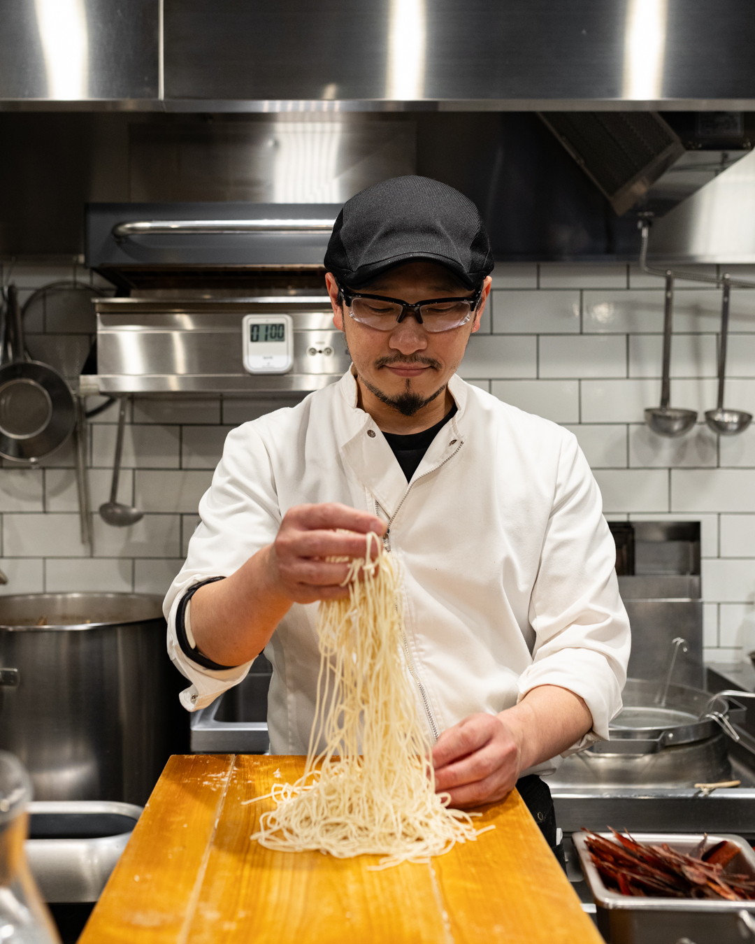 A chef preparing ramen noodles at Nakiryu in Tokyo